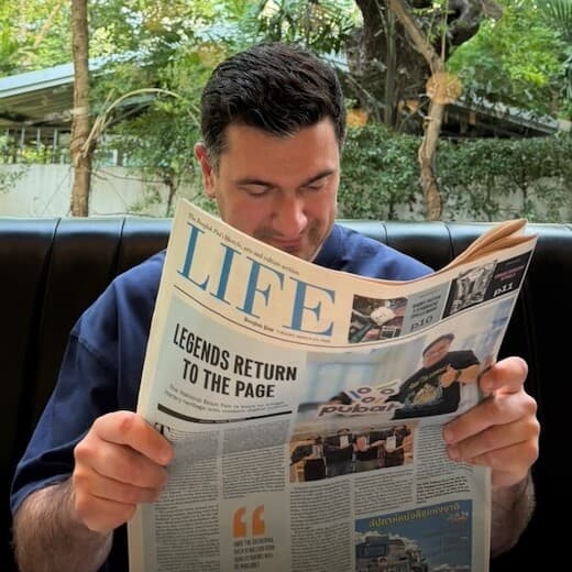 Anton Tuyakhov, founder of MVPHatch, reading a newspaper in a cafe